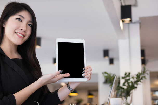 businesswoman hold digital tablet at workplace. young woman show - Fotó, kép