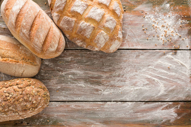 Bread background with copy space on rustic wood - Фото, изображение