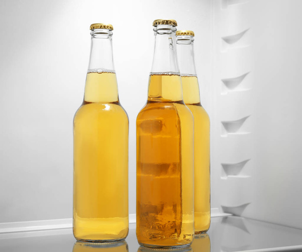 Bottles of lemonade in fridge - Foto, afbeelding
