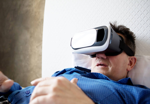 Senior man with virtual headset or 3d glasses. - Photo, image