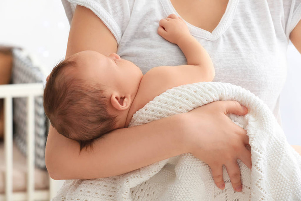 Mother holding sleeping newborn at home, closeup - Φωτογραφία, εικόνα