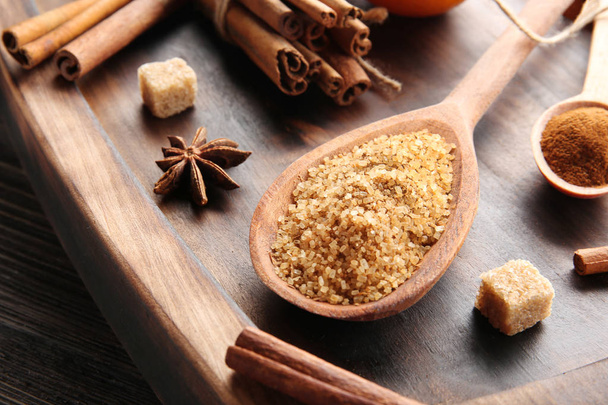 Cinnamon sugar in wooden spoon on serving board - 写真・画像