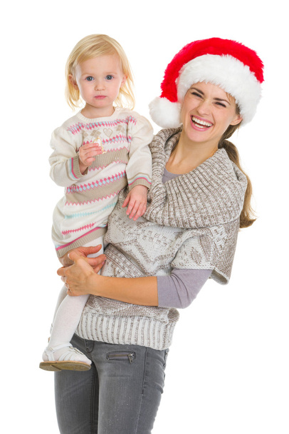 Christmas portrait of happy mother and eating cookie baby girl - Foto, Bild