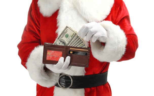 Santa Claus holding purse with money on white background - Foto, afbeelding