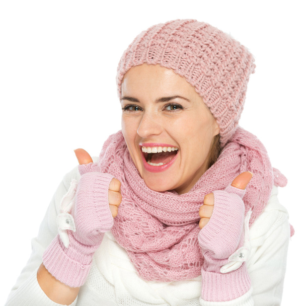 Smiling woman in knit scarf, hat and mittens showing thumbs up - Fotó, kép