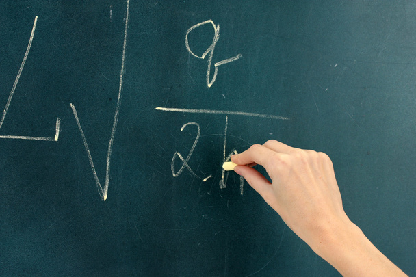 Physics formula written on blackboard with chalk. - Zdjęcie, obraz
