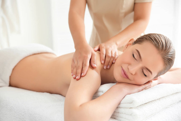 Young beautiful woman having massage in spa salon - Foto, imagen