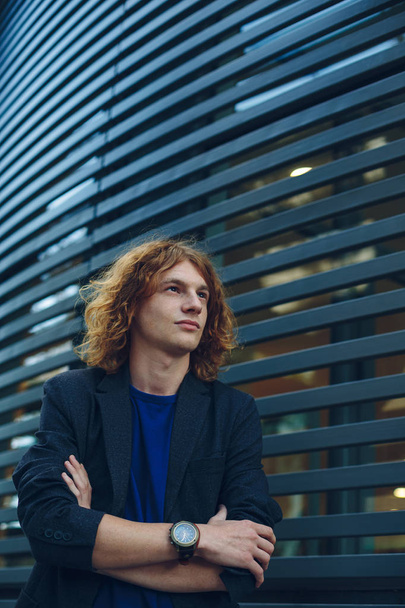 Portrait of red haired man over urban futuristic background - 写真・画像