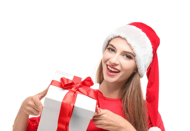 Beautiful young woman in Santa hat holding giftbox, on white background - Zdjęcie, obraz