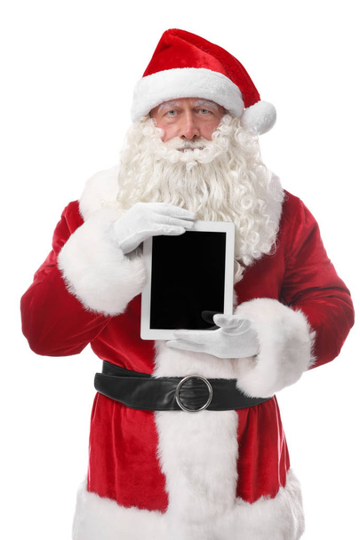Santa Claus holding tablet on white background - Foto, afbeelding