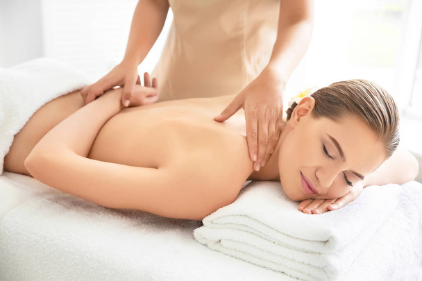 Young beautiful woman having massage in spa salon - Fotó, kép