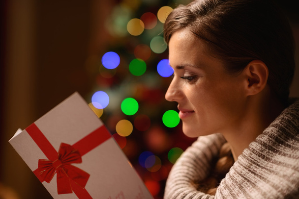 Young woman reading Christmas postcard - Foto, Imagem