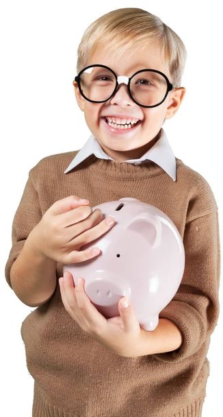 boy in glasses holding piggy bank - Foto, afbeelding