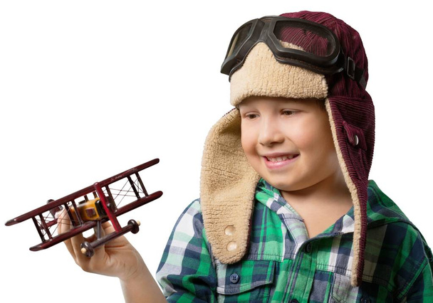 Little boy with wooden plane isolated on white background - Zdjęcie, obraz