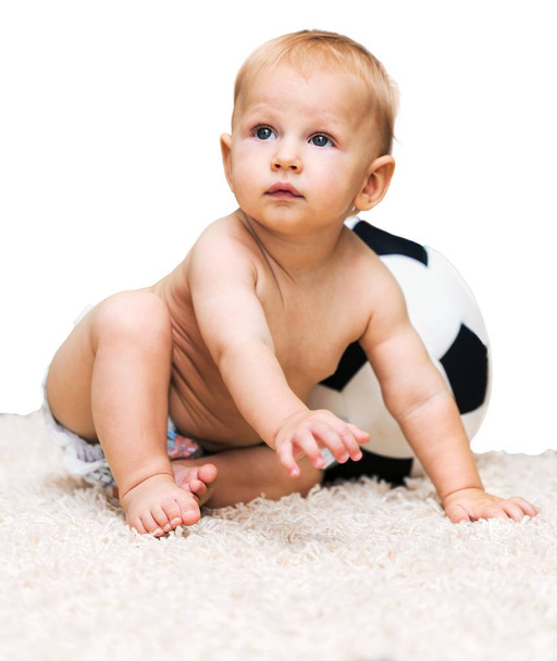 cute little boy sitting on white carpet - Foto, immagini