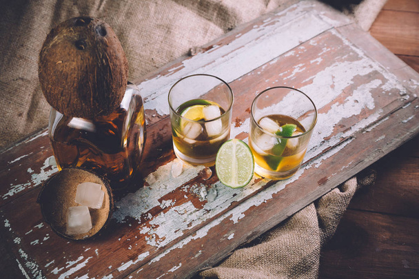 whiskey with ice, a bottle of rum tequila... - Foto, afbeelding