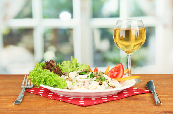 Delicatessen seafood salad with rice in glass on bright background - Photo, image