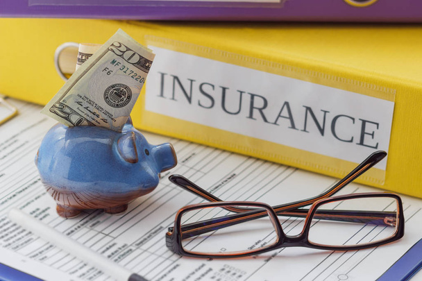 Clean insurance form, folders, pen, piggy bank and glasses - Foto, Bild