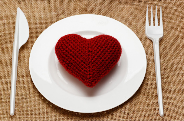 Red heart in plate with knife and fork - Photo, Image