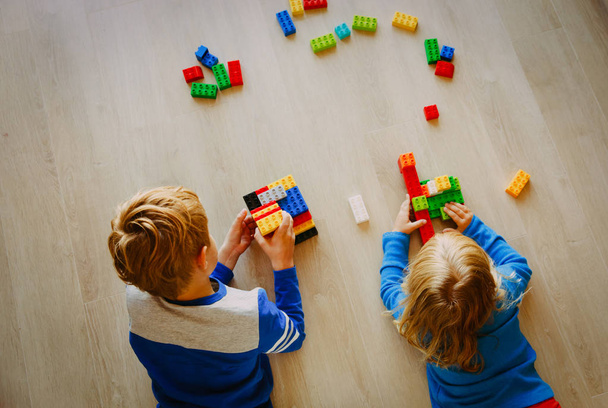 little boy and girl play with plastic blocks - Photo, Image