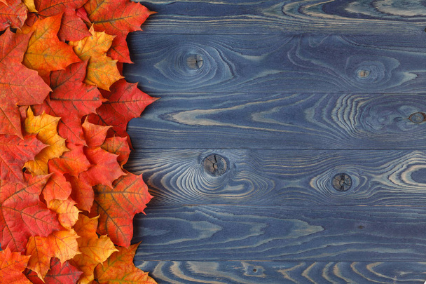 Autumn leaves over a wooden background - Photo, Image