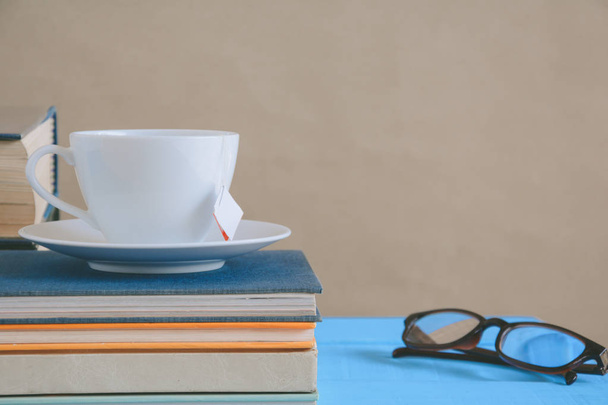 Book glasses and tea on the desk with study and education concep - Foto, Imagem