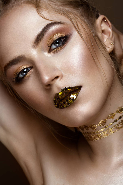 beautiful girl with golden shiny make-up and stars on her lips. Beauty face. - Fotó, kép