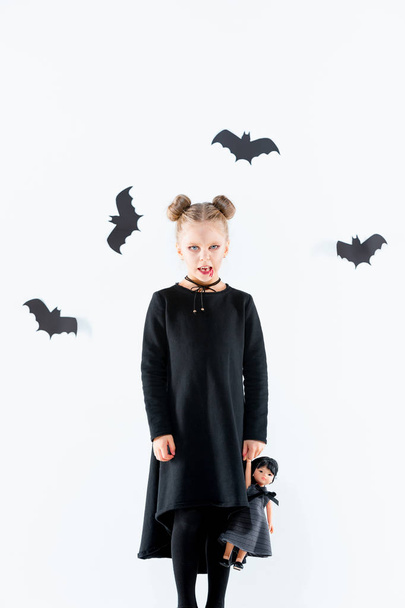 Little girl witch in black dress over magical accessories. Halloween, the studio evening. - Foto, Imagem