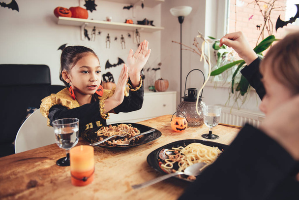 girls in costumes eating spaghetti  - Фото, зображення