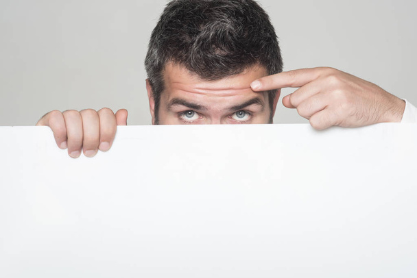 Hipster hide face behind white paper. - Photo, Image