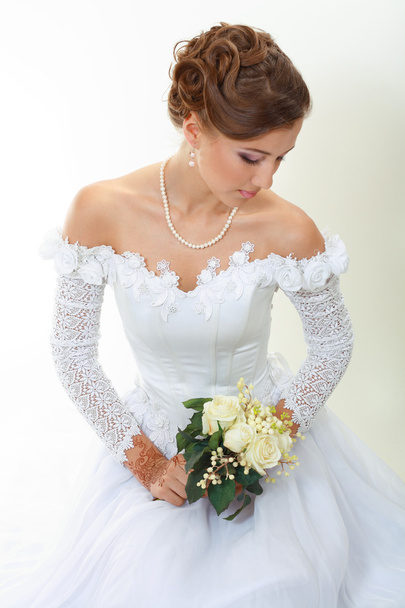Beautiful young woman with bouquet - Фото, изображение