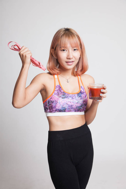 Healthy Asian girl diet with tomato juice and measuring tape on  - Фото, зображення