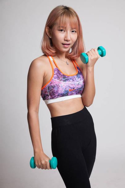 Beautiful Asian healthy girl exercise with dumbbell. - Fotoğraf, Görsel