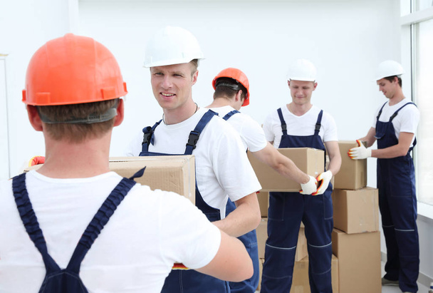 Group of people builders with boxes - Valokuva, kuva