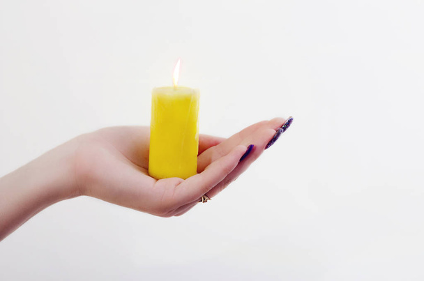 conflagrant candle is in a palm - Foto, afbeelding