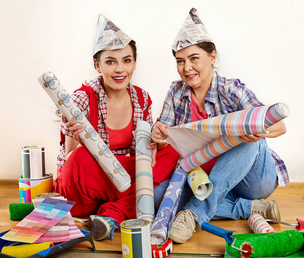 Repair home women holding Bank with paint for wallpaper. - Photo, Image