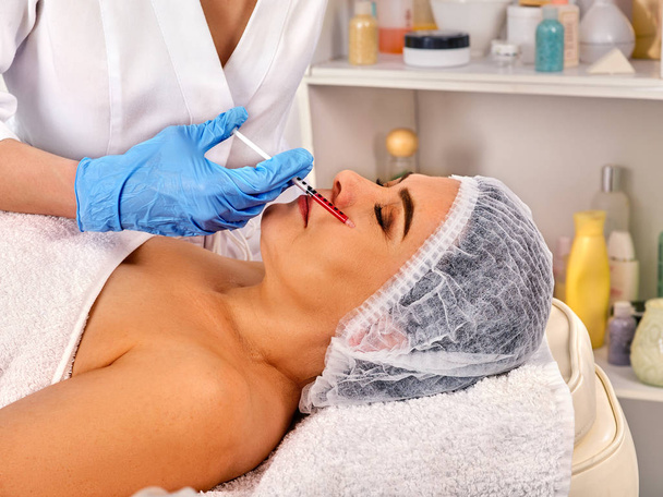 Dermal fillers lips of woman in spa salon with beautician. - Photo, Image