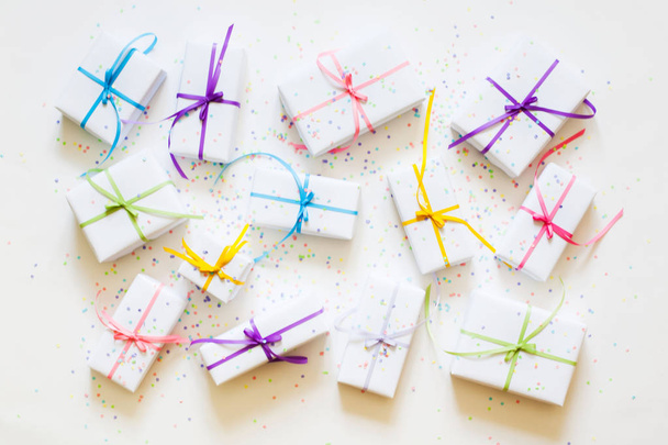 White gift boxes with colored ribbons. - Fotografie, Obrázek