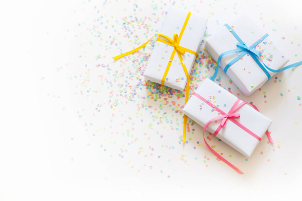 White gift boxes with colored ribbons. - Photo, Image