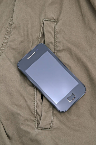 smartphone in pocket jacket. A close up - Fotografie, Obrázek