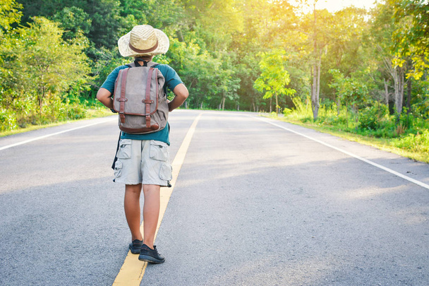 Happy Asian boy backpack in the road and forest background - Φωτογραφία, εικόνα