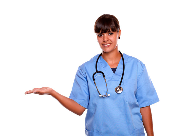 Pretty nurse holding out her palm copyspace - Foto, imagen