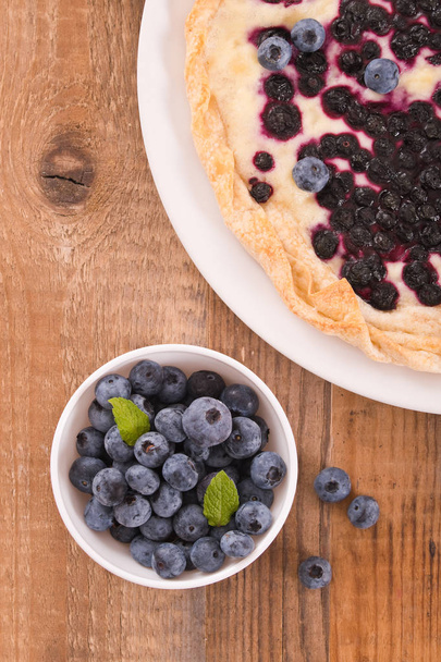 Blueberry tart on white dish.  - 写真・画像