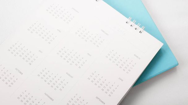 Blurred calendar page on white background. - Photo, image