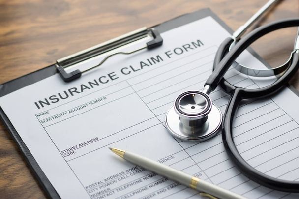 health insurance claim form with stethoscope on wood table selec - Foto, imagen