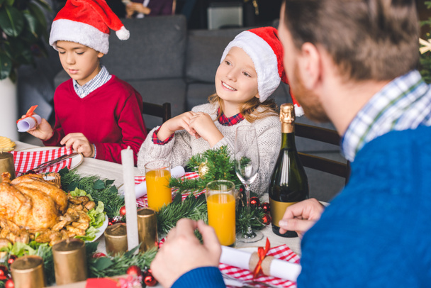 father sitting at christmas table with kids - Photo, Image