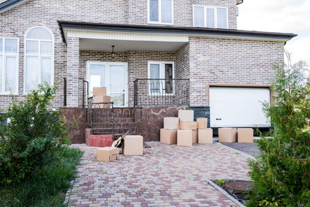house with stacks of cardboard boxes - Photo, Image