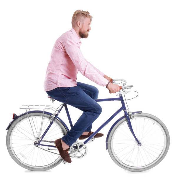 Young handsome man with bicycle on white background - Foto, imagen