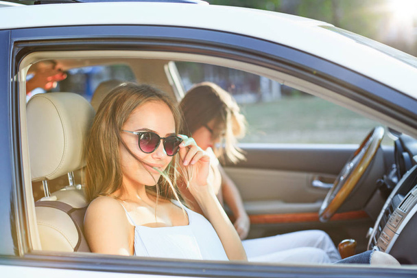 Молодые женщины в машине улыбаются
 - Фото, изображение