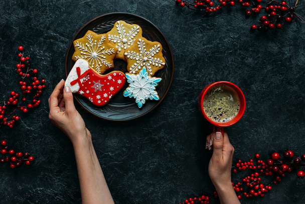 hands with gingerbreads and coffee  - Photo, Image